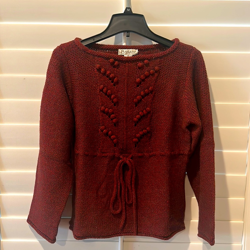 70% Acrylic/ 20% wool Size “M” pullover with waist string and popcorn details